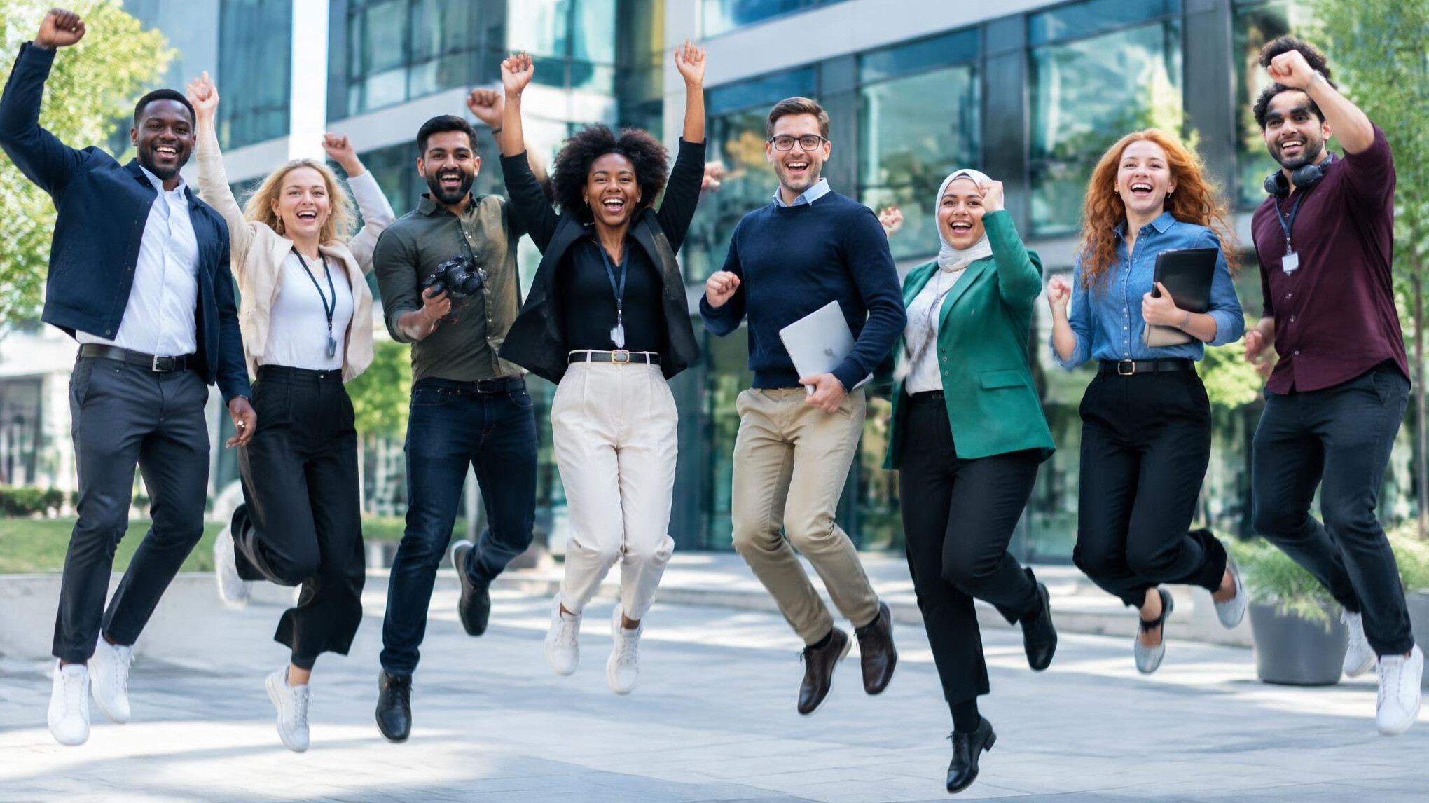 Diverse group of media professionals celebrating outdoors